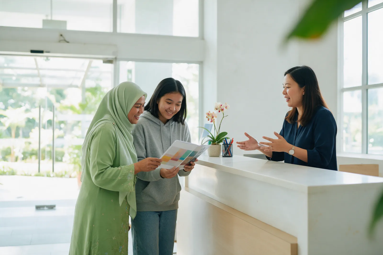 A mother and daughter talking with an advisor at a bright college admissions counter